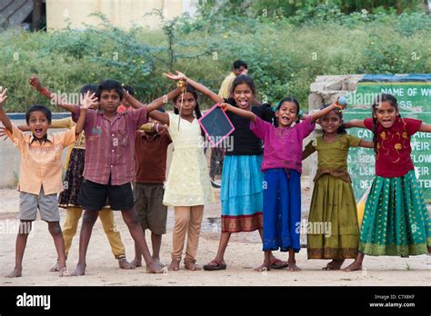 Happy Young Rural Indian Village Children Laughing Waving And Smiling