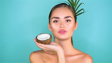 nourishing skin here s how massaging your face with coconut oil can promote skin health