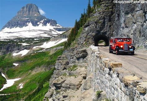 An Iconic Red Bus Passing Through Logan Pass On The Going To The Sun