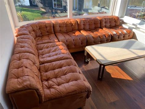 The fibers in the leather abrade one another. 1970s Leather Modular Sofa Repair | The Leather Surgeons