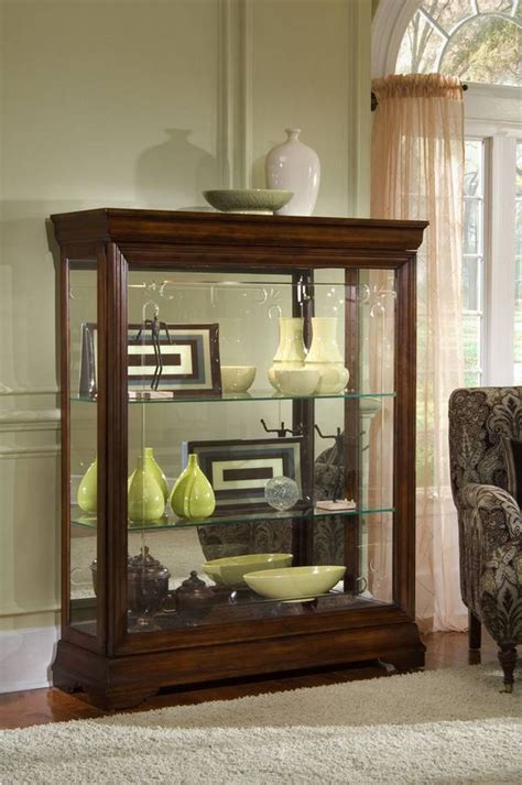 With three glass shelves, and a wood bottom shelf, a traditional mirrored back. Pulaski Gallery Mantel Curio PF-21236 at Homelement.com
