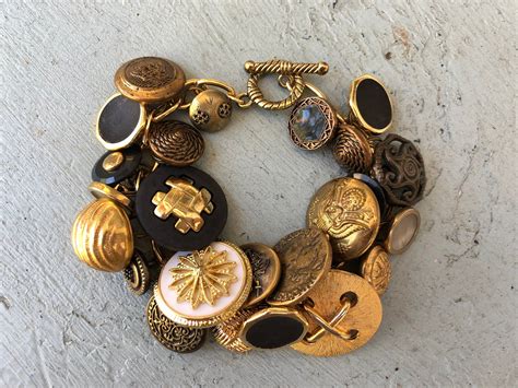 Black And Gold Antique Button Bracelet With 25 Buttons On Gold Tone Charm