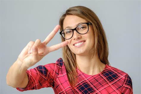 Cheerful Woman Showing Peace Sign With Her Fingers Stock Image Image