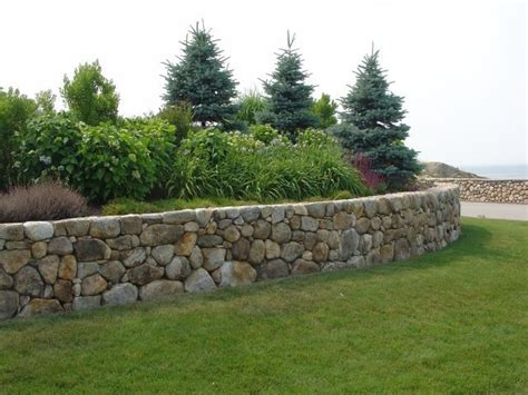 Mortared stone walls need a concrete footing to keep them from cracking due to frost heave. Curved stone wall, dry (no concrete) construction. | Stone ...