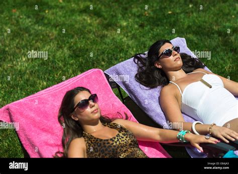 Two Babes Sunbathing On Loungers In Garden Stock Photo Alamy