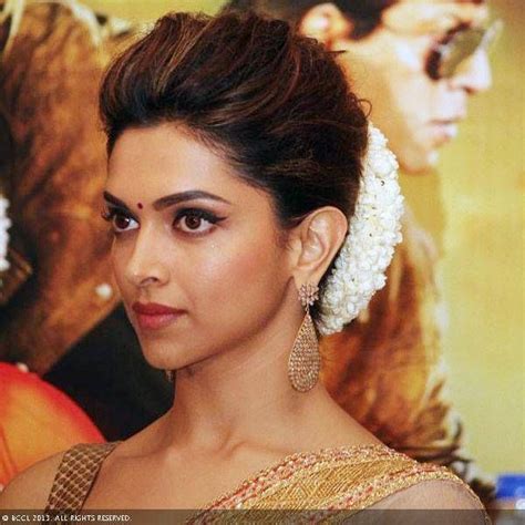 Deepika's hairstyle - classic indian bun with a gajra | Wedding bun hairstyles, Indian wedding ...