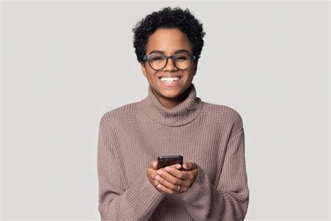 Excited Happy African American Young Woman Holding Smartphone In Hands