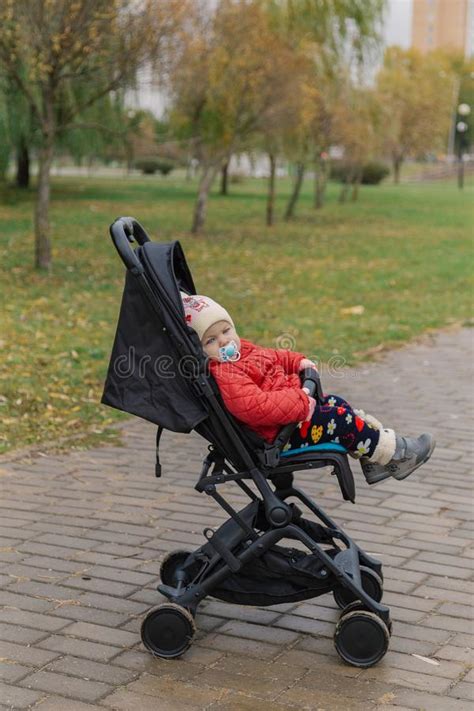 The Little Baby Is Sitting In The Pram Stock Photo Image Of Daughter