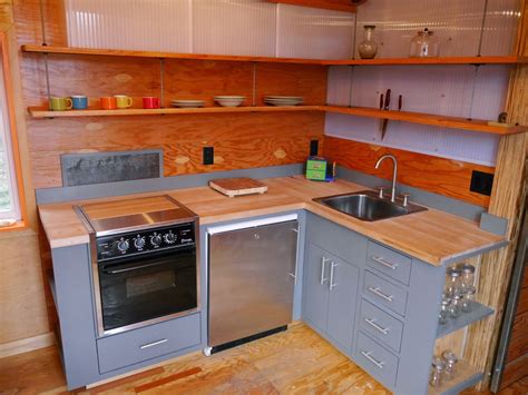 Refrigerator, two burner cooktop, and full size sink. Relaxshacks.com: A GREAT Tiny House Modern Kitchen in "The ...