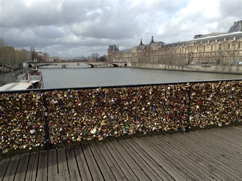The Fence Is Covered With Padlocks And Locks