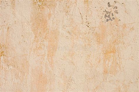 Grunge Background Of Cracked Peeling Walls With Peeled Putty In Beige
