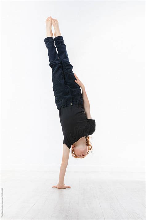 Boy Performing A One Armed Handstand By Stocksy Contributor Tim
