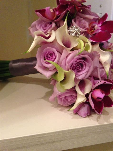 ocean song roses picasso callas with purple philo orchids and bling created by designs by