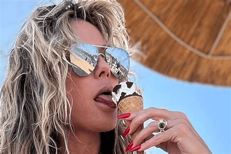 As Heidi Klum Enjoys An Ice Cream Cone While Wearing A Tiny White Bikini She Displays Her Bust