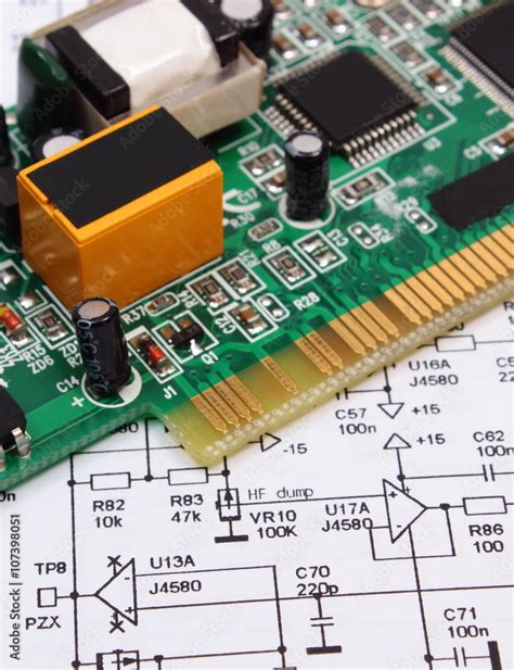 Printed Circuit Board Lying On Diagram Of Electronics Technology Stock