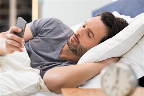 Man Checking Phone In Bed Stock Image Image Of Phone 68277285