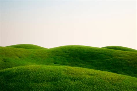 A Field Full Of Green Grass And Hills Stock Photo Download Image Now