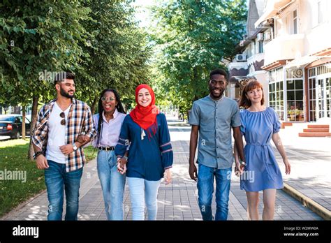 Multiracial Group Of Friends Walking In The Street Stock Photo Alamy