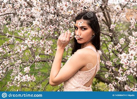 Attractive Young Beautiful Lady Enjoying Spring Plum Blossom Flowers