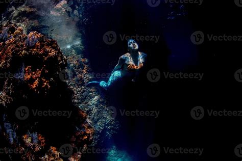 Mermaid Swimming Underwater In The Deep Blue Sea 12205314 Stock Photo