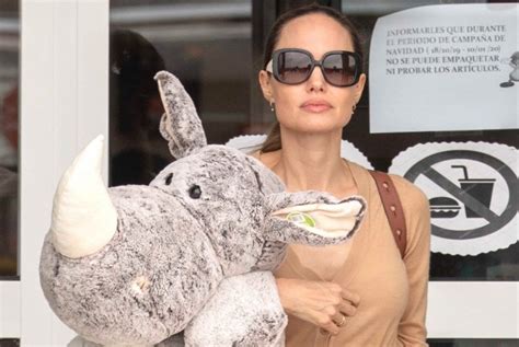 Angelina Jolie Wrangles A Giant Rhino Stuffed Toy In Filming Break