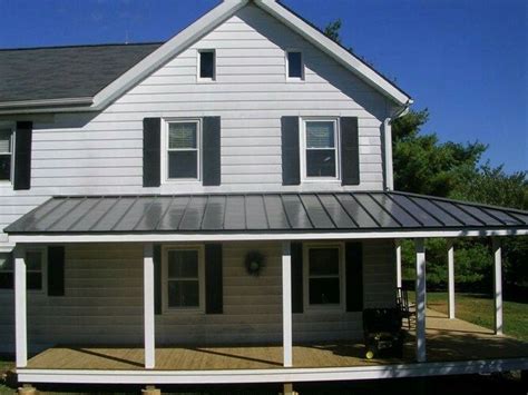 A Large White House With A Metal Roof