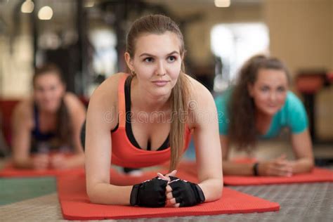 Attractive Young Women Leaning On Their Arms Doing Exercise For