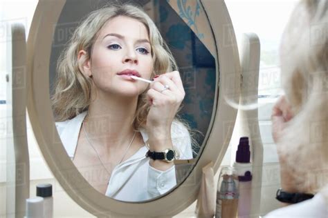 Teenage Girl Looking In Mirror Applying Make Up Stock Photo Dissolve