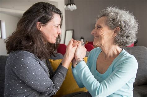 Free Photo Happy Elderly Woman And Her Daughter Laughing And Holding Hands