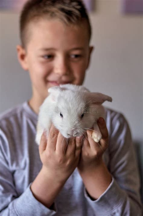 A Boy With A White Rabbit In His Hands Stock Image Image Of Funny