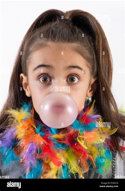 Cute Little Girl Blowing A Chewing Gum Bubble With Wide Surprised Eyes