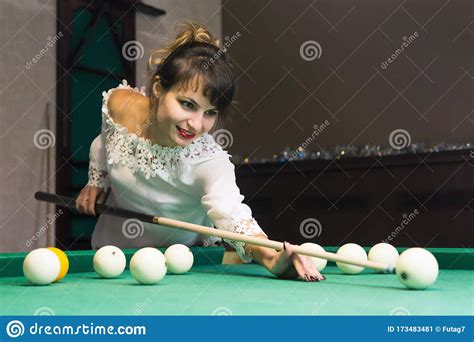 A Brunette Woman Plays Billiards In A Nightclub Stock Image Image Of