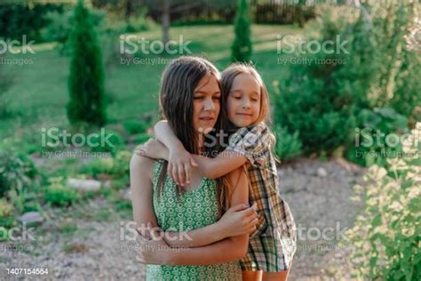 Portrait Of Two Little Girls Hugging Each Other Stock Photo Download