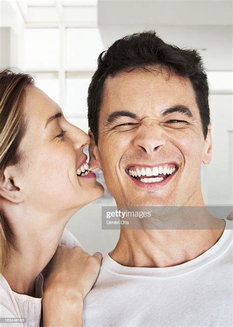 Woman Biting Laughing Mans Ear Photo Getty Images