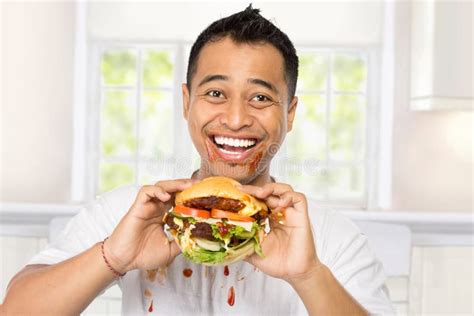Happy Young Man Eating A Big Burger Stock Image Image Of Nutrition