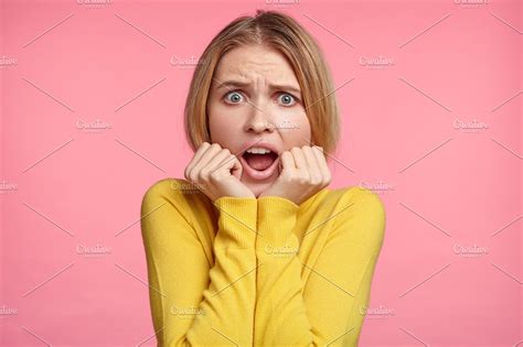Portrait Of Shocked Female Model Looks Scared After Seeing Awful