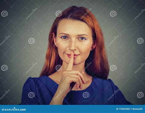 Secretive Young Woman Placing Finger On Lips Asking Shh Quiet Silence