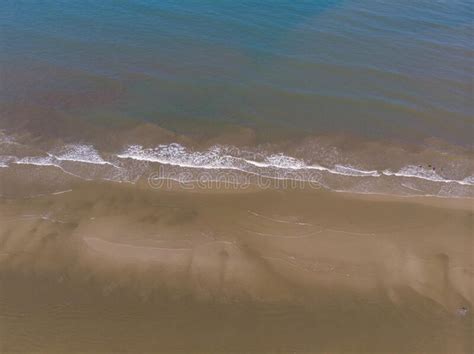 Aerial Drone Image View Of Ocean Waves Crashing On Beach Stock Photo