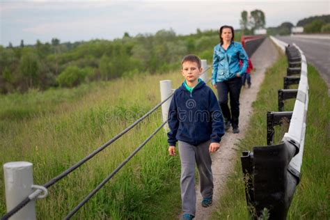 The Child Walks Along The Safe Zone Near The Highway Stock Image