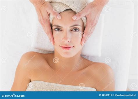 Attractive Woman Receiving Facial Massage At Spa Center Stock Image