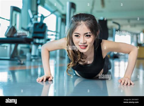 Asian Woman Fitness Girl Do Pushing Ups At Fitness Gym Healthcare And