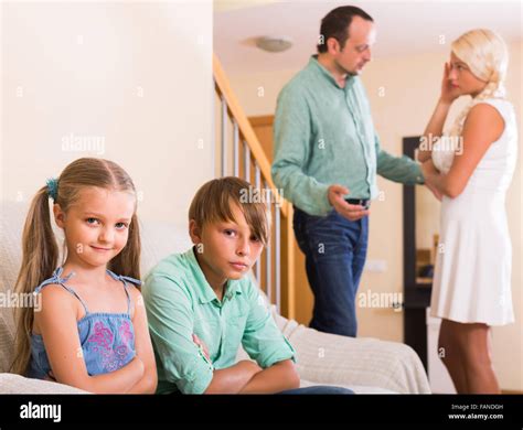 Sad Spanish Children In Silence While Parents Arguing At Home Stock