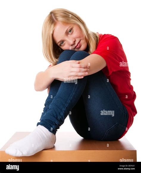 Cute Teenager Girl Feeling Lonely Sitting Alone With Knees Pulled Up And Arms Around Legs