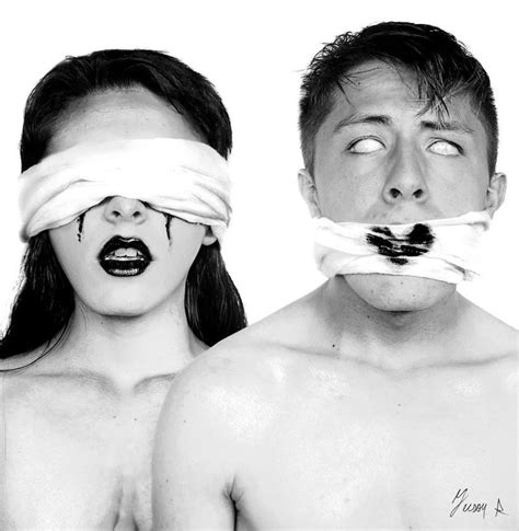 Two People With Blindfolds Covering Their Eyes And Mouths One Man Has