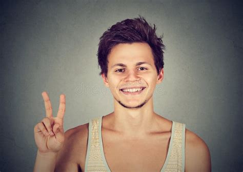 Young Man Handsome Student Holding Up Peace Victory Two Sign Stock