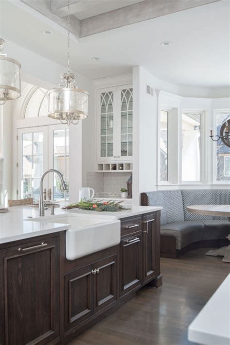 Dark brown kitchen cabinets with white island; Painted White Kitchen with Dark Wood Island - Crystal Cabinets