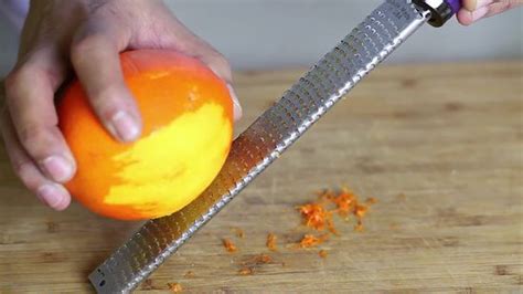 Meanwhile, using a channel (cocktail) zester, zest oranges to make long, curly strips of zest; orange zest strips