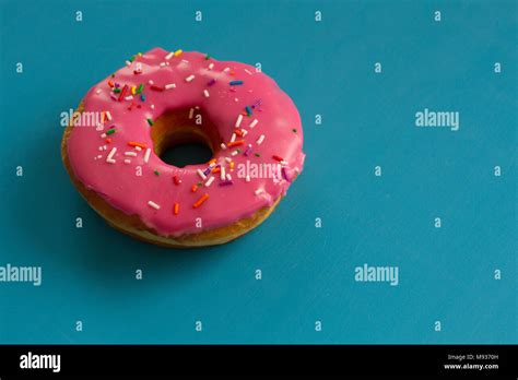 A Pink Frosted Doughnut Stock Photo Alamy