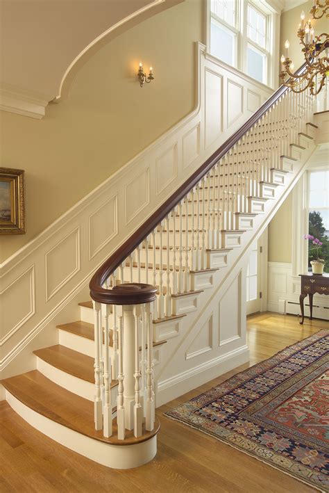 Formal Curving Staircase With Paneling Traditional Staircase