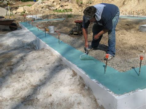Gypsum board held up from slab sealant. Capillary Break Coating - Fine Homebuilding
